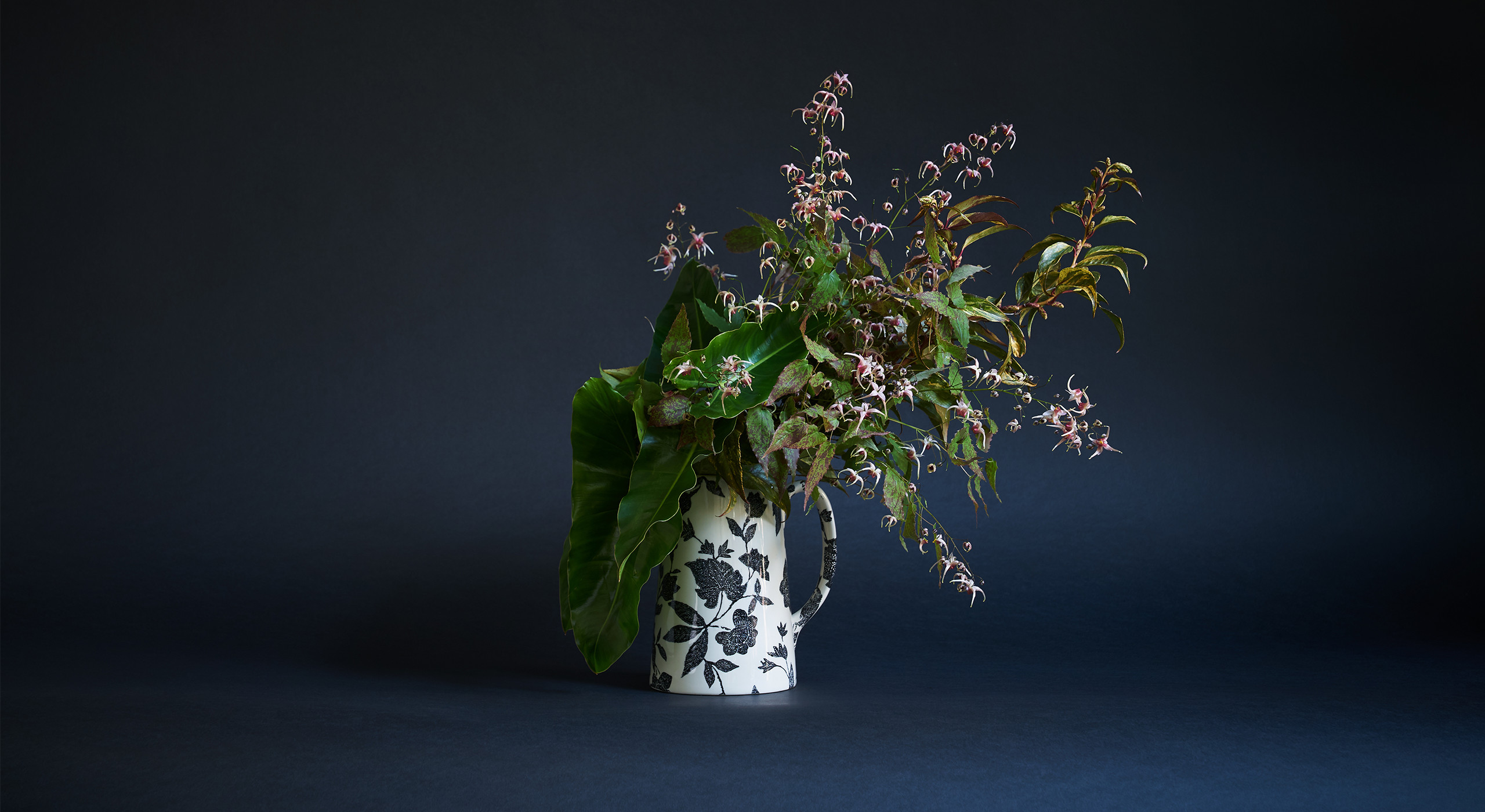 &ldquo;This is a perfect choice if somebody was looking to create an arrangement with a woodland feel. At the heart of this one is epimedium, which is actually a very common garden flower that has beautiful foliage and a short blooming season in the spring. It&rsquo;s all about the texture and speckling, which is something I come back to again and again. With everything I do, I want people to have to look a little harder than they usually might. This also has Leucothoe&mdash;a common shrub that&rsquo;s very hardy and often overlooked&mdash;as well as philodendron, a houseplant that&rsquo;s super long-lasting in the vase. I&rsquo;ve tried to transform them from appearing waxy and tropical to something you might discover in a wetland bog.&rdquo;