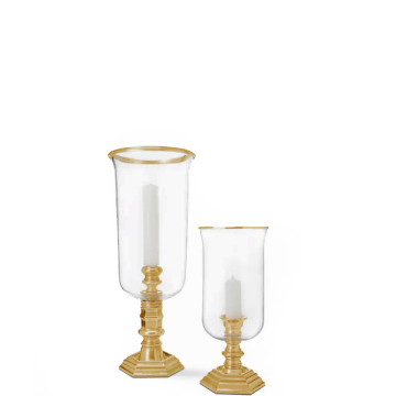 White candles in clear hurricanes and gold stems.