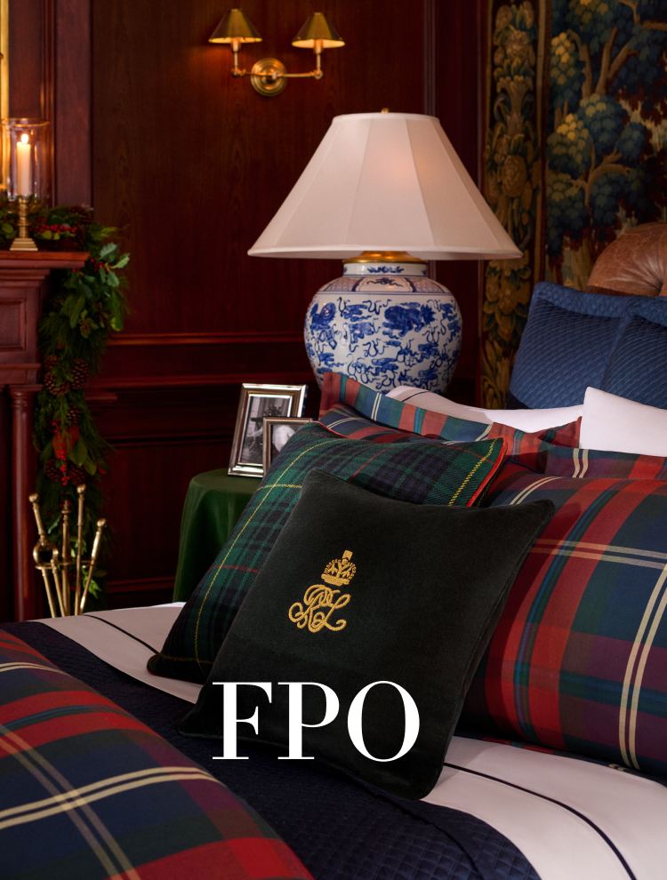 Green and red plaid pillows on a bed.